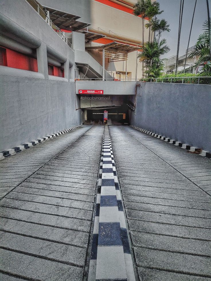 an empty parking garage with black and white checkered flooring