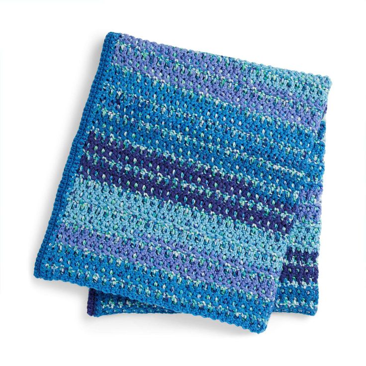 two blue and purple crocheted dishcloths sitting on top of each other