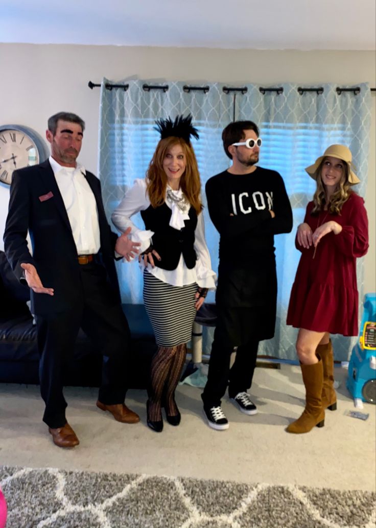 four people dressed up in costumes standing next to each other and posing for the camera