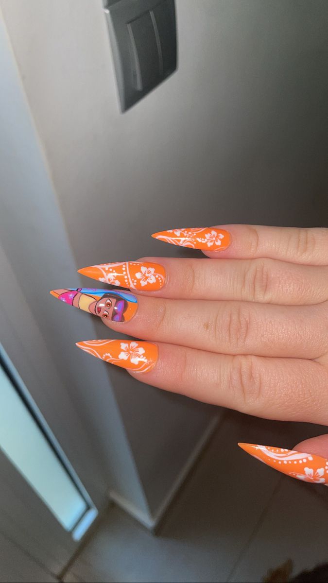 a woman's hand with orange and white nail polish on her nails, in front of a refrigerator