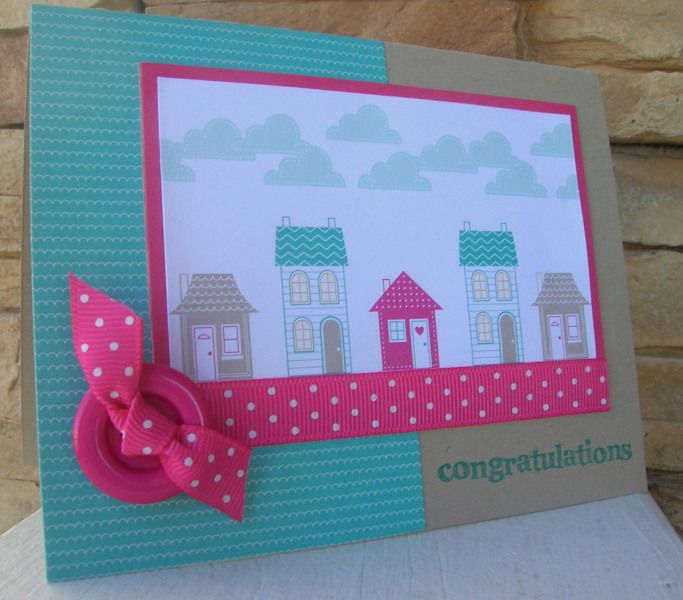 a close up of a card with a pink bow on the front and blue background