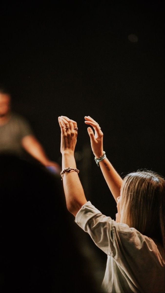 two people raising their hands in the air