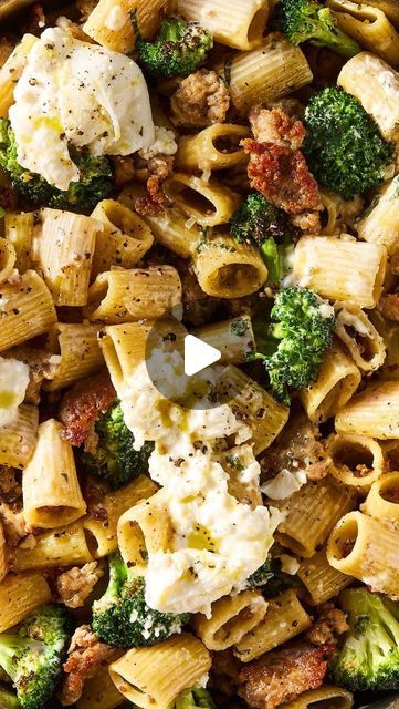 a bowl filled with pasta and broccoli covered in cheese