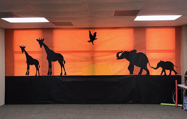 an elephant and giraffe mural on the wall