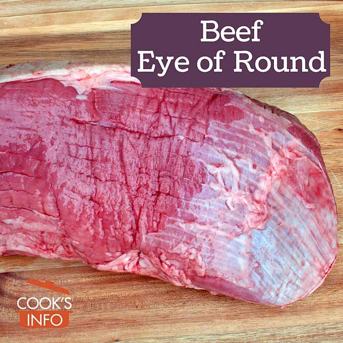 beef eye of round on wooden cutting board with title overlay reading beef eye of round