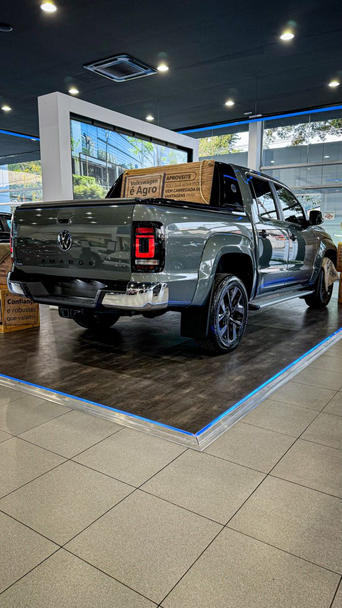 the truck is parked in the showroom with boxes on it's flatbed