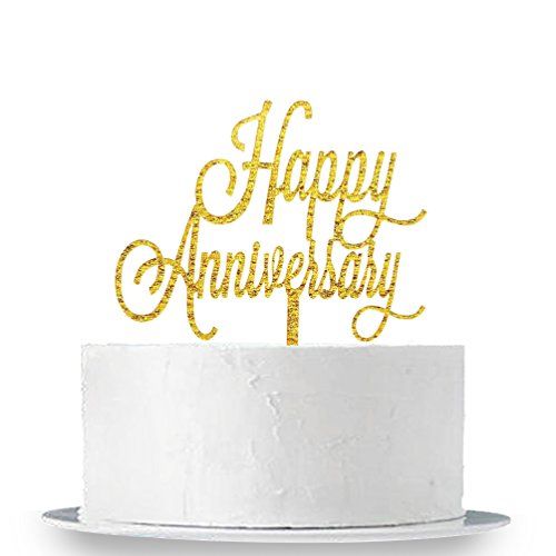 happy anniversary cake topper with gold glitter lettering on a white cake platter in front of a white background