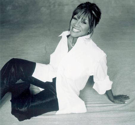 a black and white photo of a woman sitting on the ground