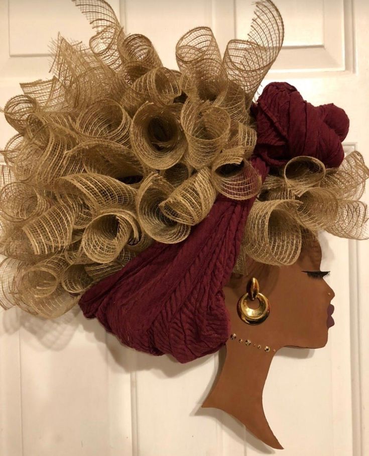 a woman's head is adorned with burlap and gold hair pieces,