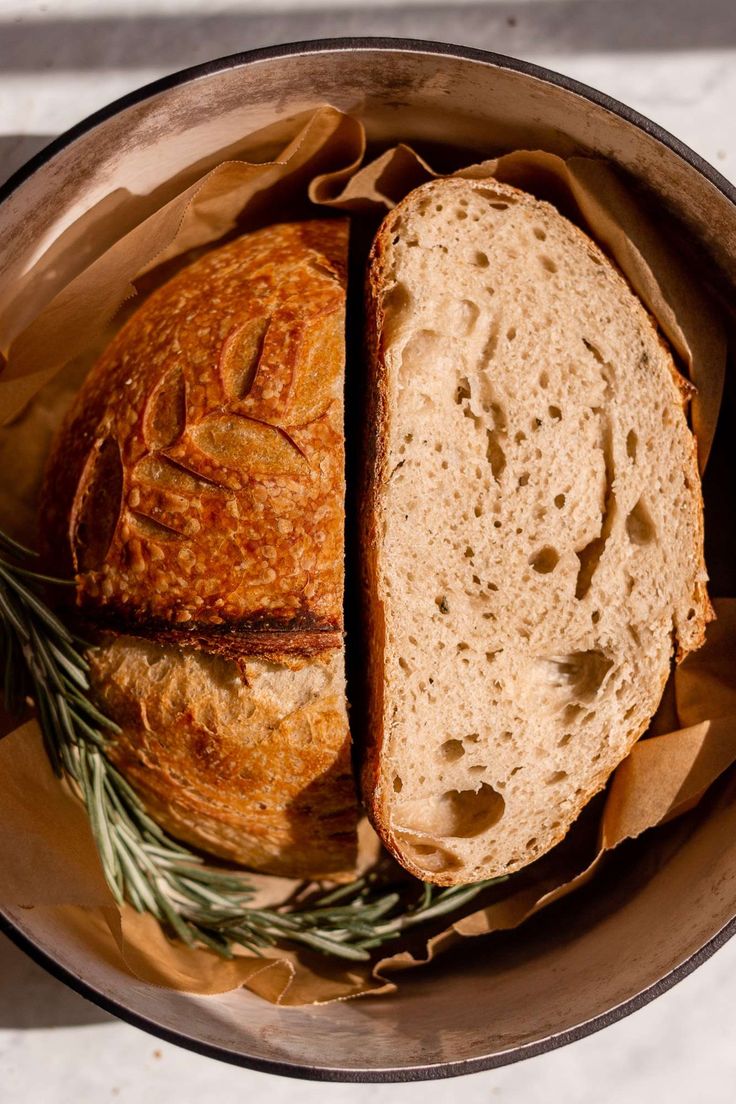 a loaf of bread sitting on top of a wooden bowl