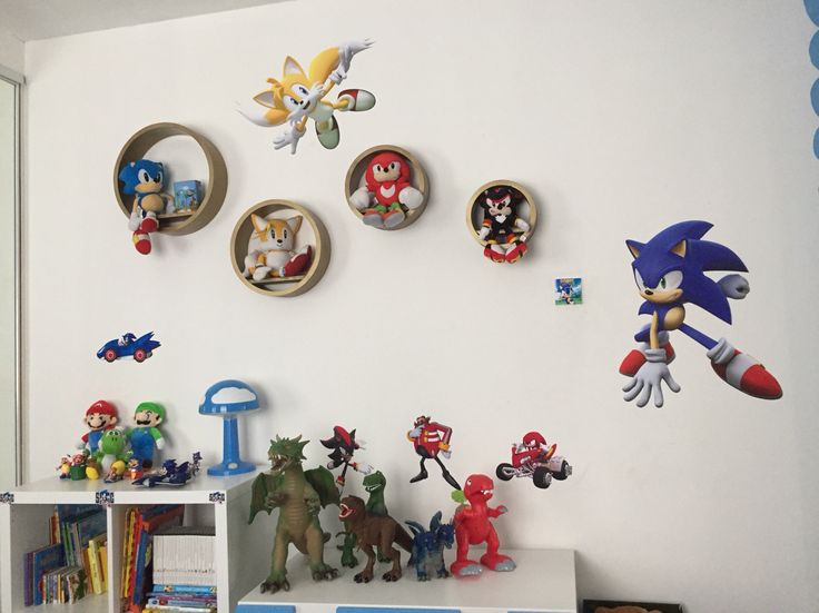 a room filled with lots of toy figurines on top of a white shelf