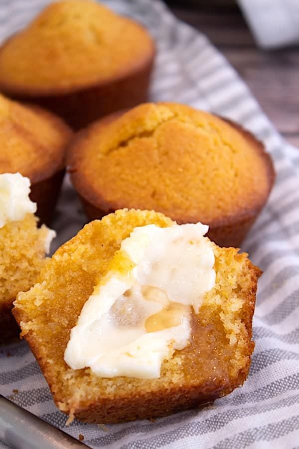 three muffins with white frosting on top sitting on a napkin next to each other