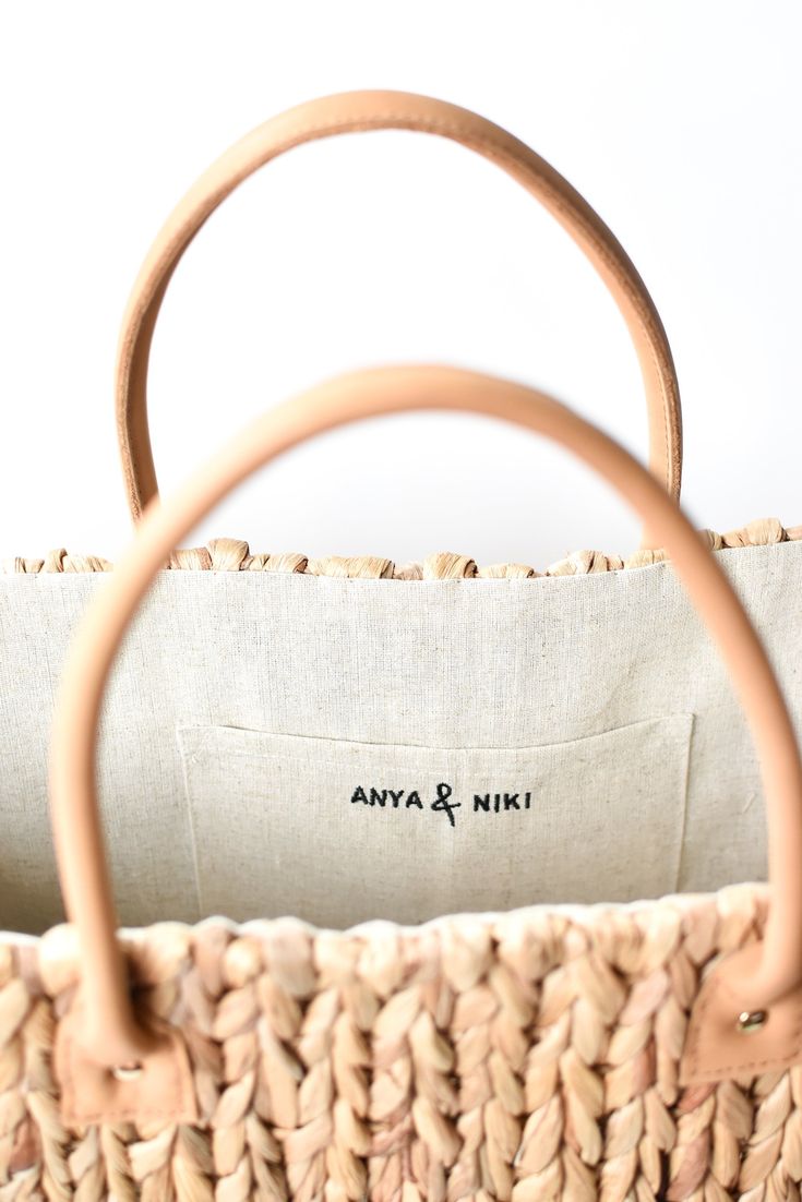 This extra large straw tote is woven from natural hyacinth and has two over-sized leather handles for carrying everything from beach gear to vintage finds. Neutral, classic and spacious, it can do it all. Content:- Hyacinth Straw - Leather- Linen Lining- Imported Size:- Width: 18.5" - Height: 11.25"- Depth: 9"- Handle Drop: 7.5" Chic Neutral Straw Bag With Handles, Neutral Rectangular Straw Bag With Handles, Rectangular Neutral Straw Bag With Handles, Chic Neutral Beach Bag With Braided Handles, Chic Neutral Straw Bag With Braided Handles, Chic Beige Beach Bag With Rolled Handles, Chic Natural Beach Bag With Handles, Neutral Straw Bag With Braided Handles For Shopping, Everyday Jute Beach Bag With Bamboo Handle