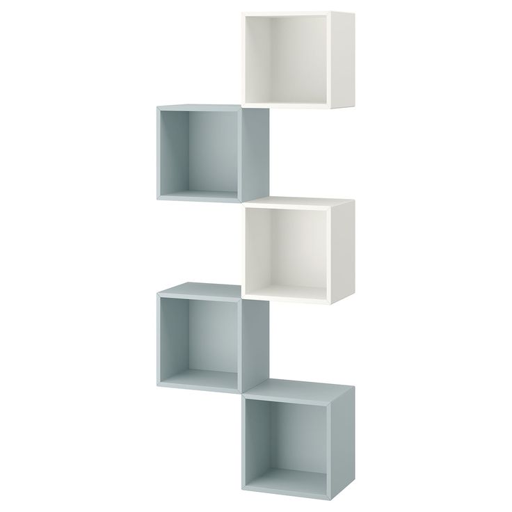 three white shelves are stacked on top of each other in the shape of cubes