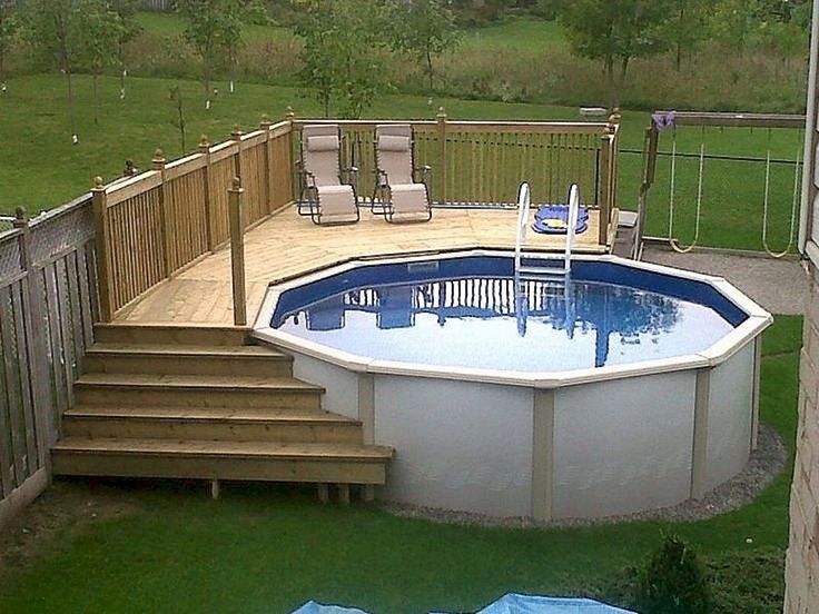 an above ground pool with steps leading up to it and a deck on the other side