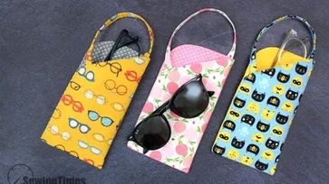 three purses with sunglasses on them sitting next to each other in front of a blue background