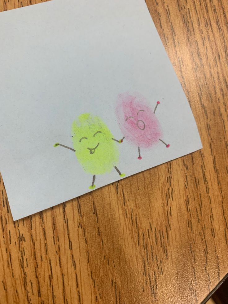 a child's drawing of two birds on a piece of paper