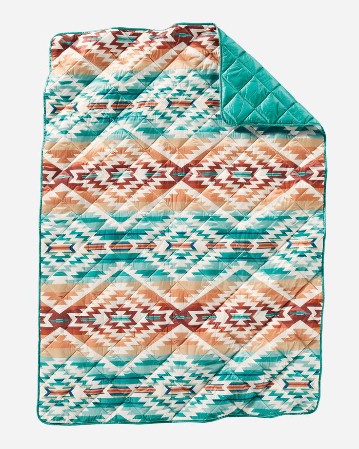 the turquoise and orange blanket is folded up