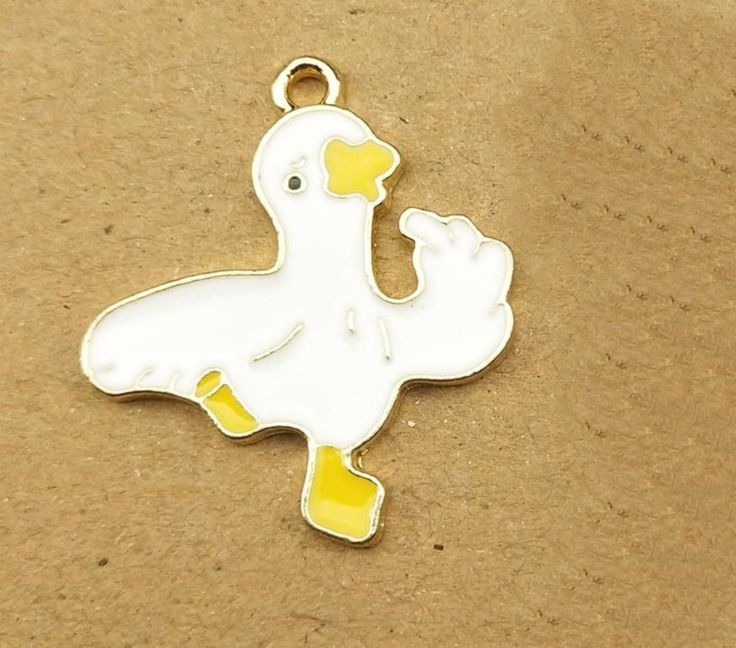 **Get this Charm for FREE with the purchase of any charm bracelet Good for charm bracelets, handbag charms, key rings, zipper pulls, and pendants Cute Enameled Dancing Goose Charm Flat back charm. Measures 1 X 3/4 inch. Zinc alloy, lead-free. Comes with a jump ring All items in stock and ships from Tennessee. Personalized White Metal Charms, White Enamel Charms For Gifts, Nickel Free White Charms For Gifts, White Novelty Jewelry With Charms, Nickel-free White Enamel Charms, White Enamel Nickel-free Charms, White Enamel Charms For Jewelry Making, White Novelty Enamel Jewelry, White Enamel Novelty Jewelry