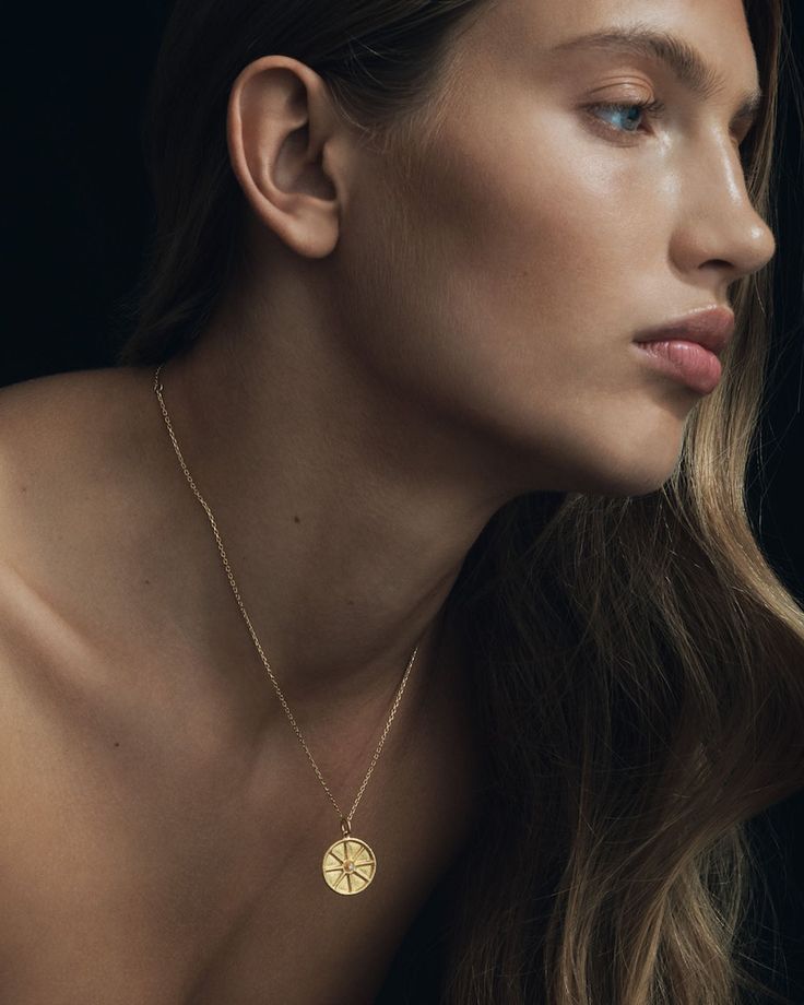 This divine necklace showcases the Star of Ishtar, symbolising love, passion and beauty. A raised rim encircles the large coin pendant that glows with the light of a natural diamond at its heart.  
 Crafted from softly textured 24k solid gold, this diamond pendant exudes a rich, tactile lustre that enhances its ancient allure. A 14k yellow gold curb chain completes this piece. Spiritual Yellow Gold Medallion Necklace With Large Pendant, Symbolic Yellow Gold Coin Pendant Necklace, Amulet Style Yellow Gold Medallion Necklace, Fine Jewelry Medallion Coin Necklace, Luxury Gold Plated Round Medallion Necklace, Luxury Gold-plated Coin Necklace With Round Pendant, Luxury Gold Plated Coin Necklace With Round Pendant, Luxury Gold-plated Round Medallion Necklace, Timeless Round Coin Pendant Necklace