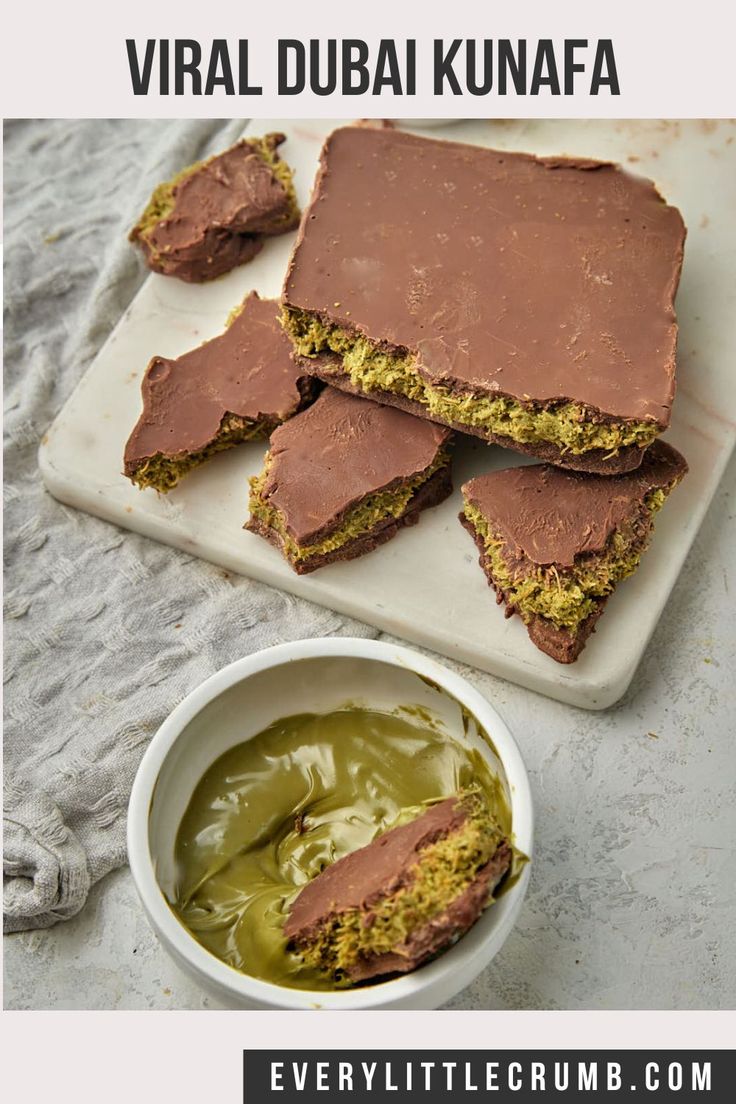 several pieces of chocolate cake on a cutting board next to a bowl of green liquid