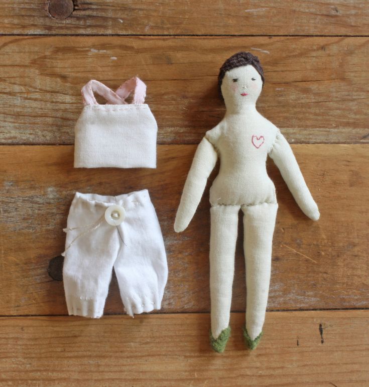 three dolls are laying on the floor next to each other and one doll is wearing white pants