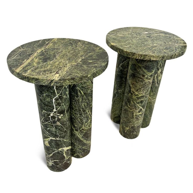 two green marble side tables sitting next to each other