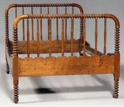 an old wooden bed frame with wood slats