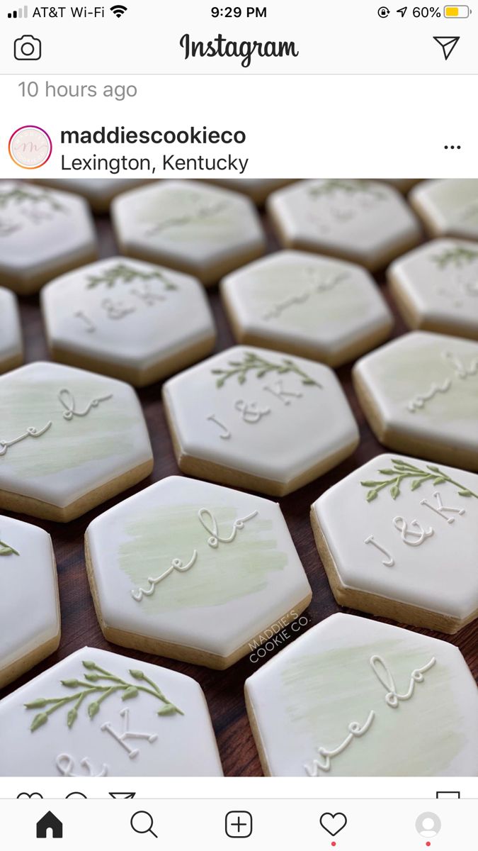 some cookies that are sitting on top of each other with icing in the shape of letters