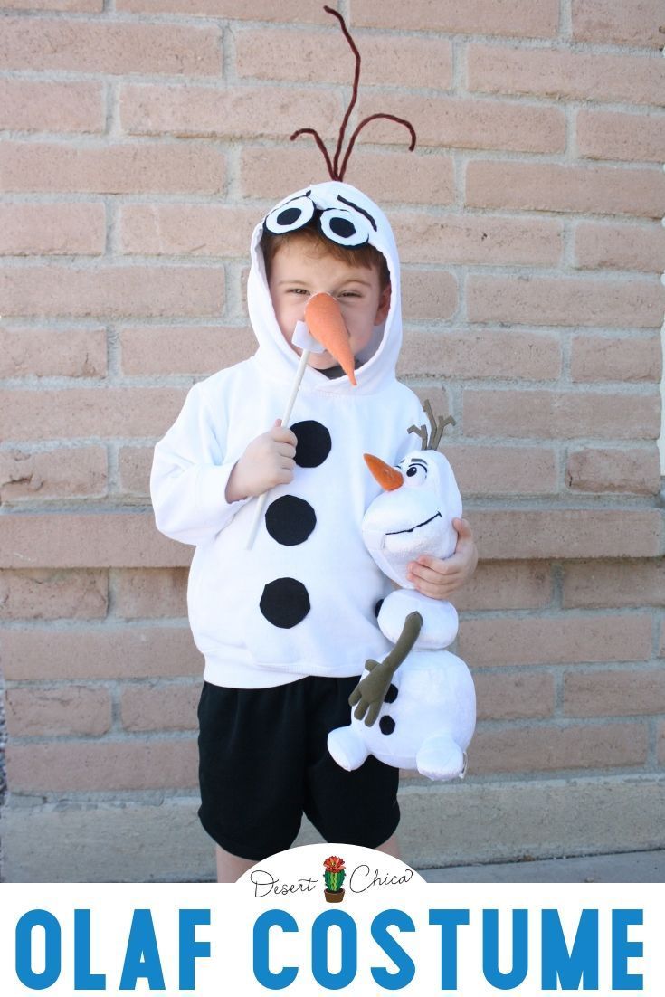 a young boy dressed as a snowman with a carrot in his mouth and nose