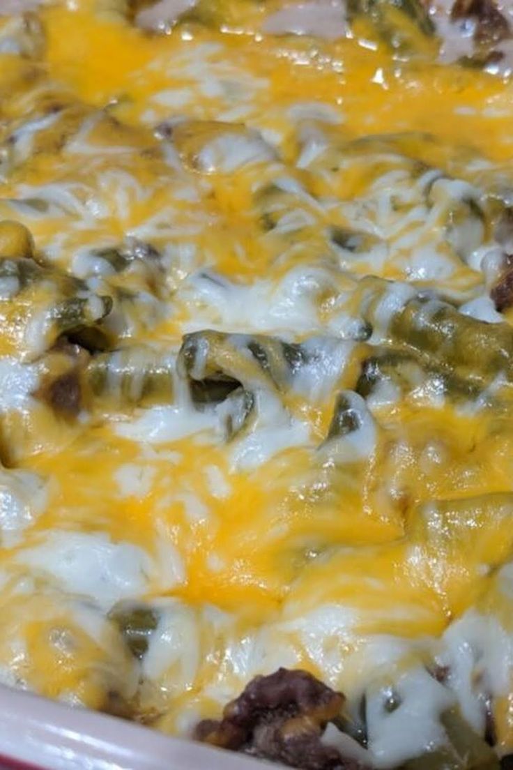 a casserole dish with cheese and meat in it