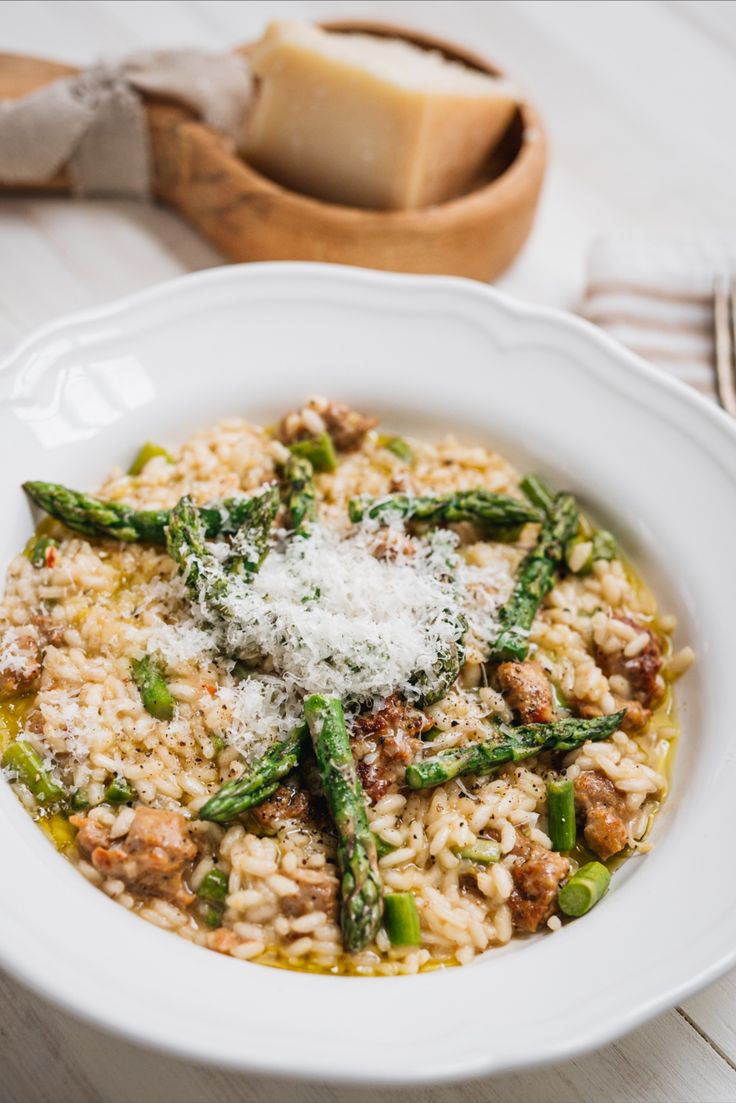 a white bowl filled with rice and asparagus