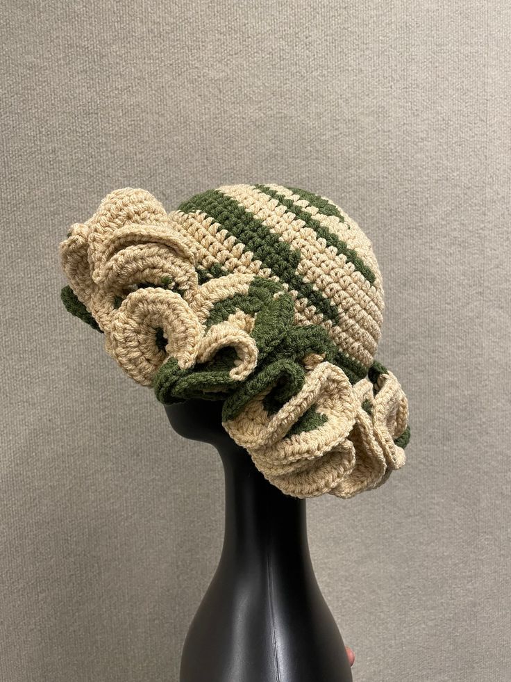 a crocheted hat on top of a mannequin head