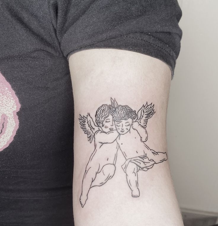 a woman with a tattoo on her arm holding onto another person's arm,