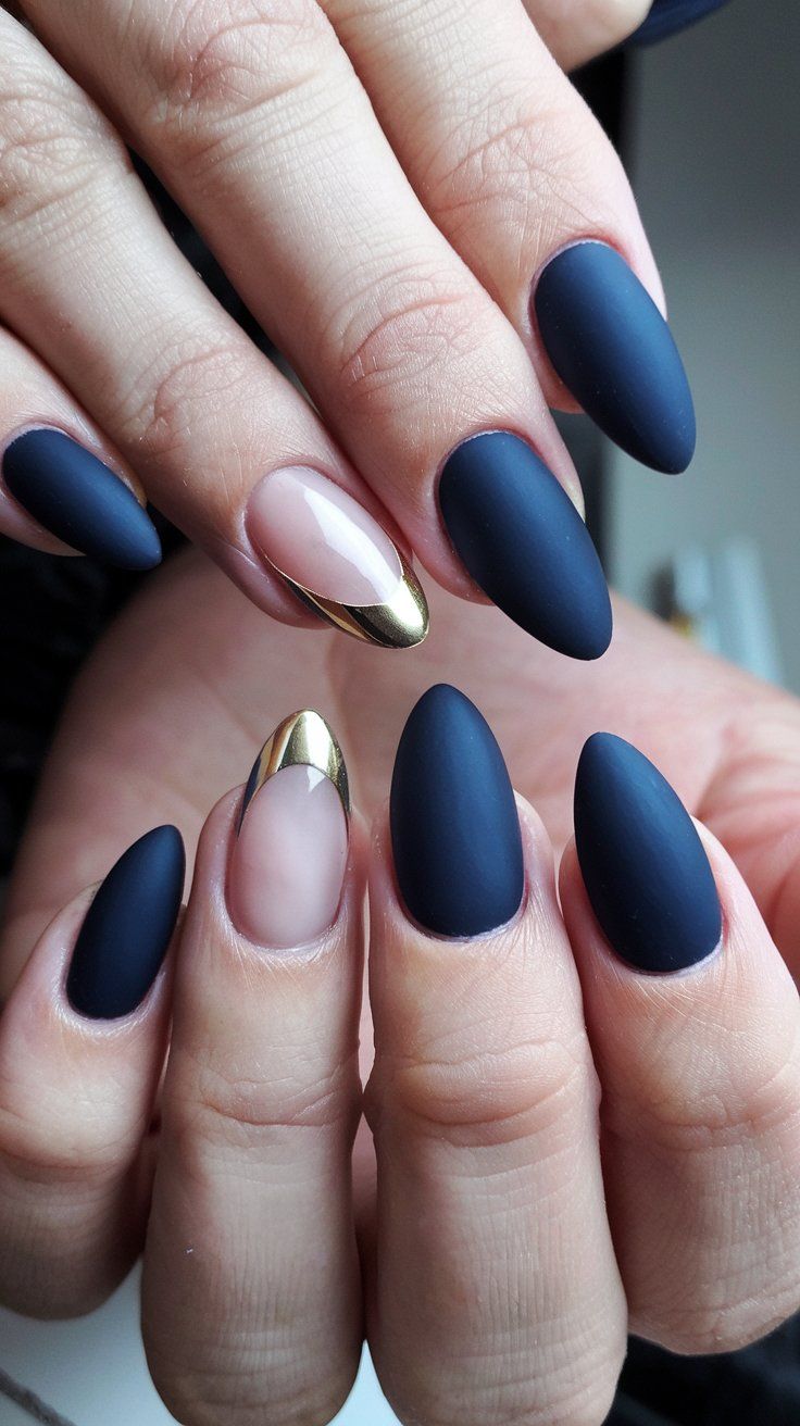 Elevate your nail game with this stunning matte navy and gold accent manicure! Featuring a chic mix of matte nails and a glamorous gold tip, this design is both elegant and modern. The unique nude accent nail adds a trendy twist, making it perfect for any occasion. Get inspired to try this sophisticated look! #NailArt #MatteNails #NailInspiration #septembernails #fallnails Navy Nails Gold Accent, Fall Nails Navy Blue And Gold, Navy And Bronze Nails, Matte Blue And Gold Nails, Navy And Gold Almond Nails, Dark Blue Nails With Silver Design, Elegant Navy Blue Nails, Ravenclaw Nail Designs, Navy And Copper Nails