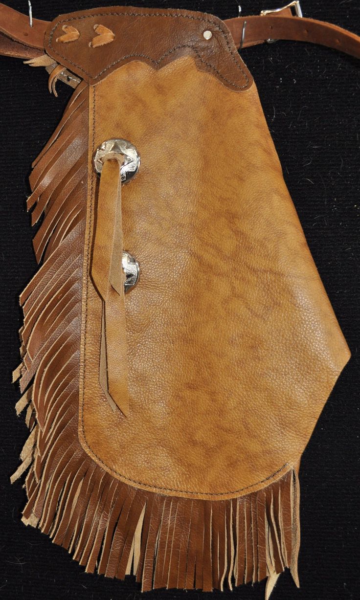 a brown leather purse with fringes on it