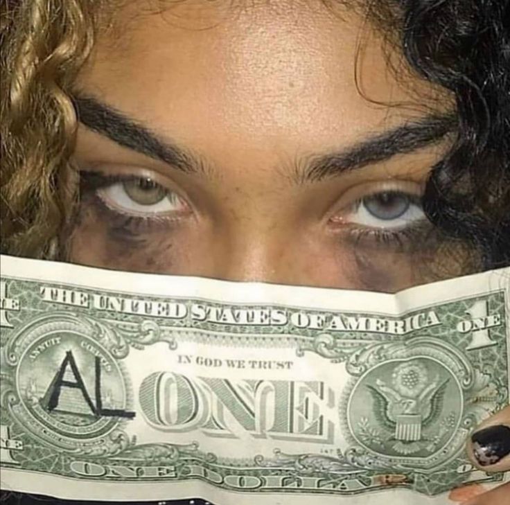 a close up of a person holding a one dollar bill in front of their face