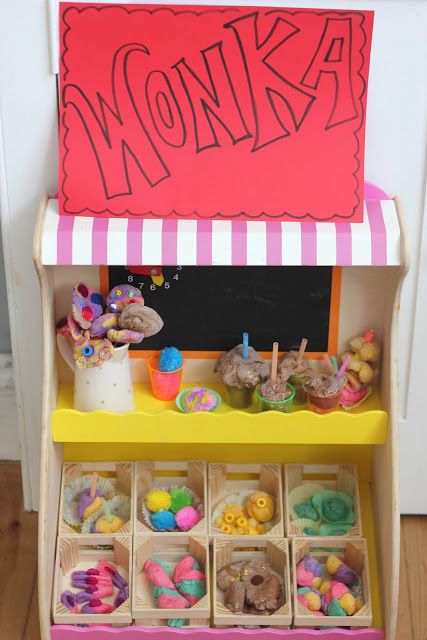 a wooden toy store with lots of toys in it's display area and a sign that says monka