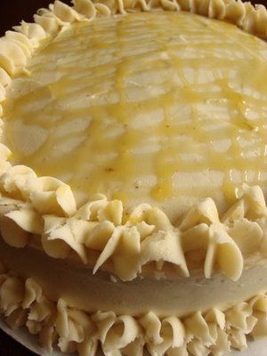 a close up of a cake on a plate with icing and ruffles