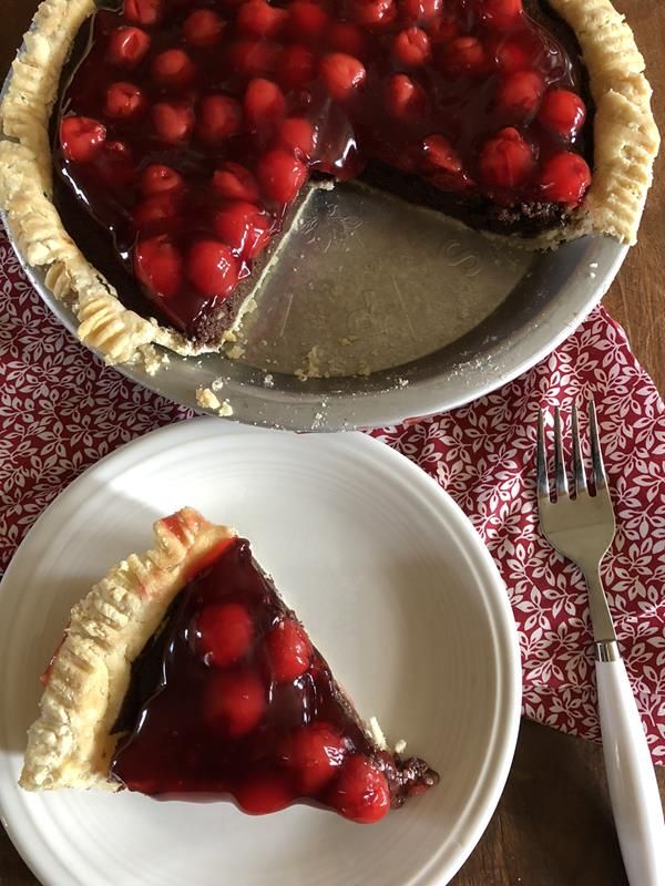 there is a piece of pie with cherries on it