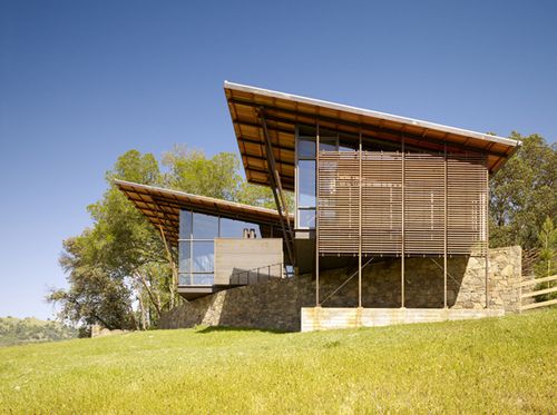 a modern house on top of a hill