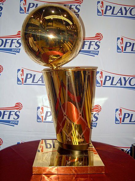 a golden trophy sitting on top of a red table