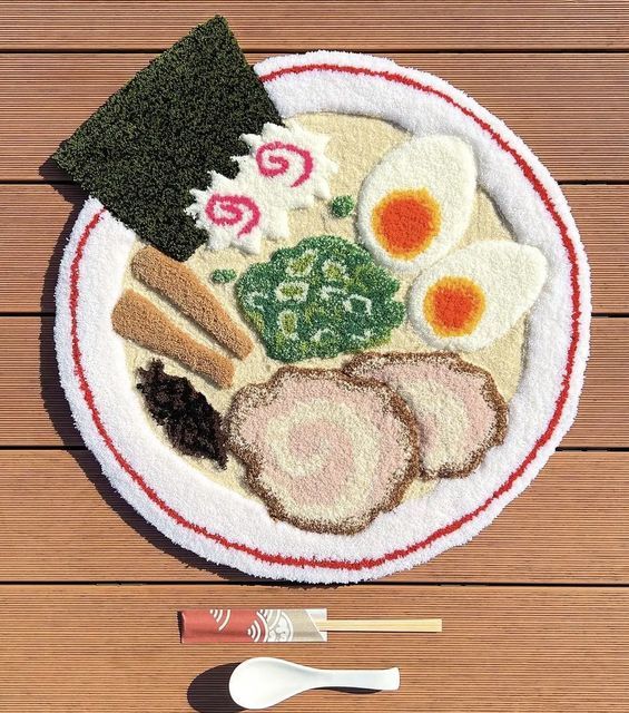 a white plate topped with different types of food on top of a wooden table next to chopsticks