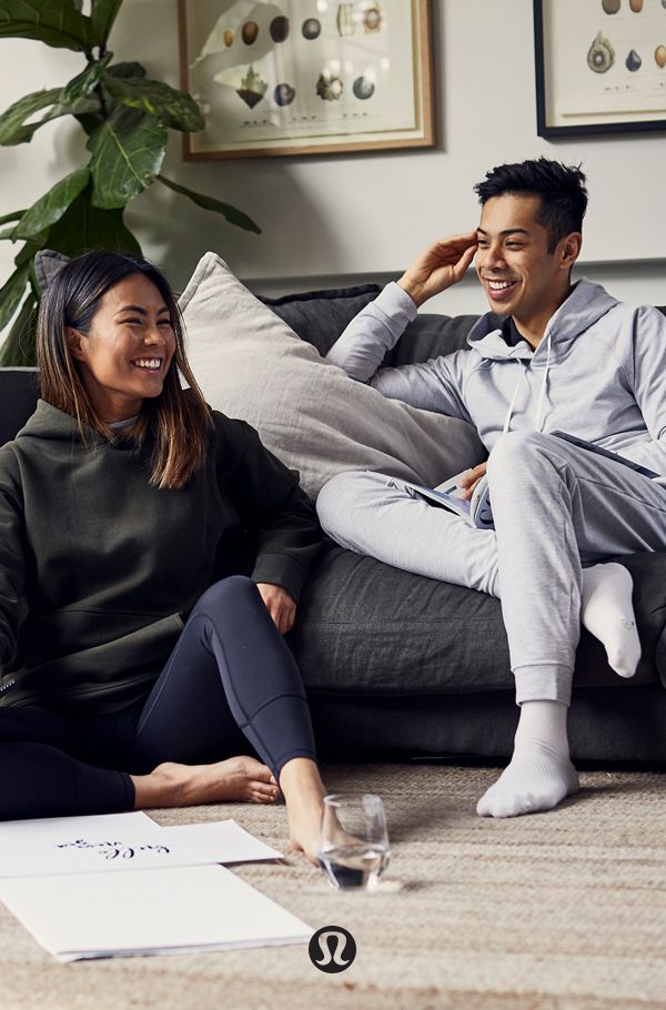 a man and woman sitting on a couch laughing