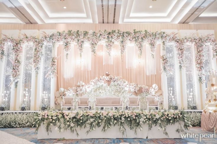 an elegant wedding setup with white flowers and greenery