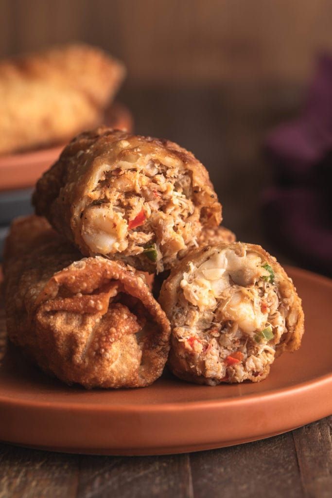 three fried food items stacked on top of each other in front of a pie crust