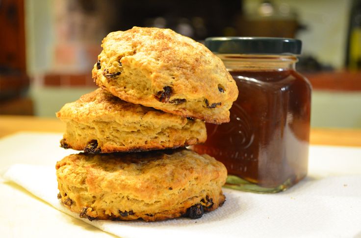 three biscuits stacked on top of each other with jam in the background