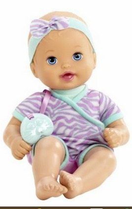 a baby doll sitting on the ground with a pacifier in her mouth and wearing a purple striped shirt