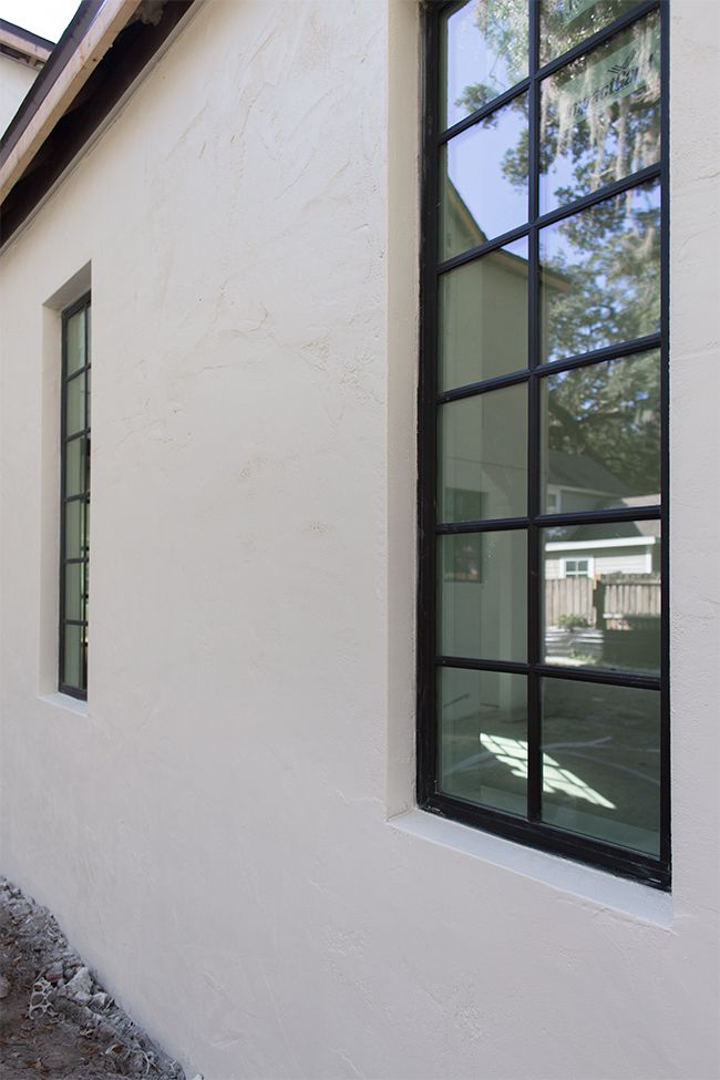 the side of a house with two windows