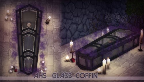 the glass coffin is surrounded by candles